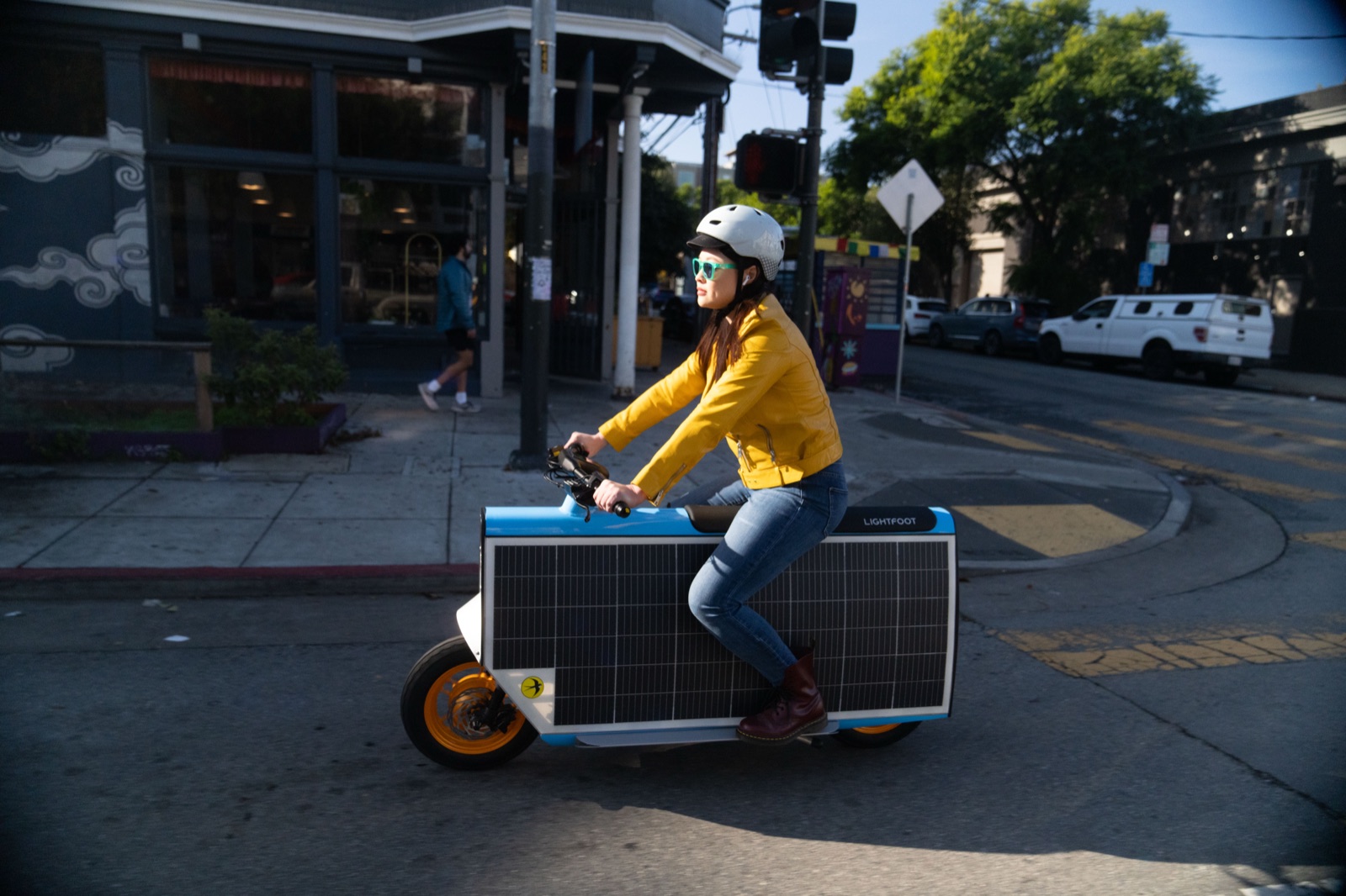 Rider crossing a city intersection, full side view
