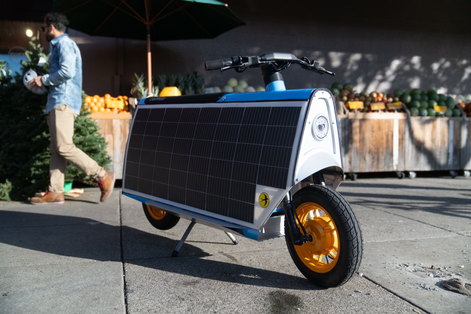 Lightfoot parked on its center stand at a farmers-market stall